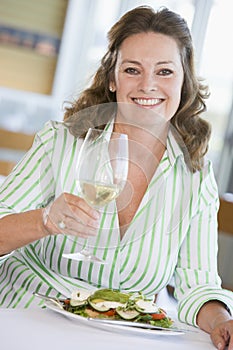 Woman Enjoying meal,mealtime With A Glass Of Wine