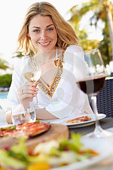 Woman Enjoying Meal In Outdoor Restaurant