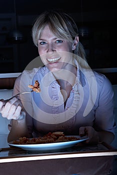 Woman Enjoying Meal Whilst Watching TV