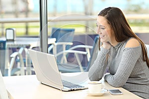 Woman enjoying media in a laptop