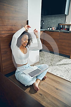 Woman enjoying a music video on her computer