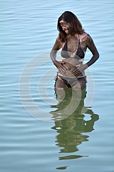 Woman enjoying the natural mineral mud sourced from the Dead Sea