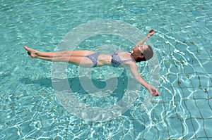 Woman enjoying natural minerals of Dead Sea, Israel