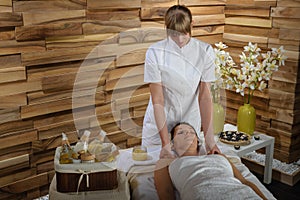 Woman enjoying neck massage at luxury spa