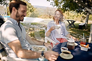 Woman enjoying  outdoor  drinking coffee with her man
