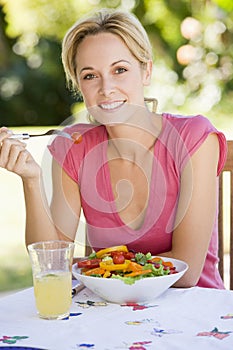 Woman Enjoying A Salad In A Garden