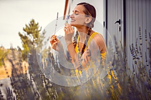 Woman enjoying the scent of Lavender on a farm