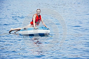 Woman enjoying the sea on an inflatable donut