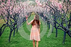 Woman enjoying spring in the green field with