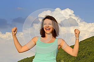 Woman enjoying summer outdoors and expressing success