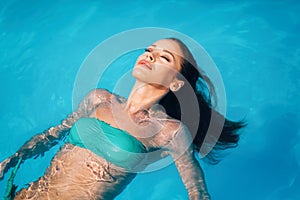 woman enjoying summer in pool