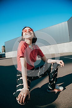 Woman enjoying of the sun and warmness while sitting a the street during the walking