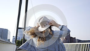 Woman enjoying sunny day on modern bridge bridge