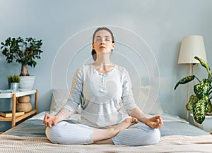 Woman enjoying sunny morning and practicing meditation