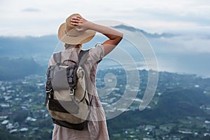 Woman enjoying sunrise from a top of mountain Batur, Bali, Indonesia