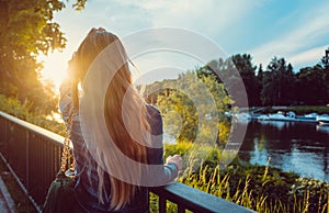 Woman enjoying the sunset over the Danube River in Regensburg