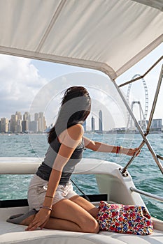 Woman Enjoying a Sunset Yacht Ride in Dubai Marina Harbor in the UAE