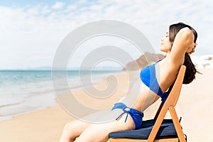 Woman Enjoying Suntan At Beach