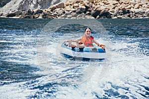 Woman enjoying surfing the sea water