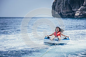 Woman enjoying surfing the sea water