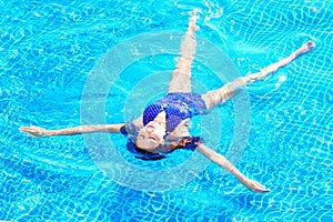 Woman enjoying a swimming pool, relax in water.