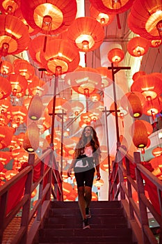 Woman enjoying traditional red lanterns decorated for Chinese new year Chunjie