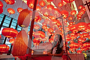 Woman enjoying traditional red lanterns decorated for Chinese new year Chunjie