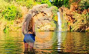 Woman enjoying tropical waterfall in Algarve