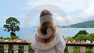 Woman enjoying vacation at luxury beach resort hotel with tropical sea view