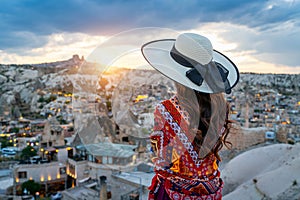 Woman enjoying view of Goreme town, Cappadocia in Turkey.