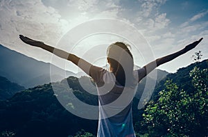 Woman enjoying the view on morning mountain