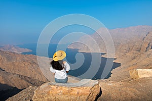 Woman enjoying view over Fjord Khor Najd in Oman