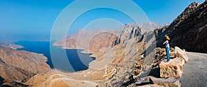 Woman enjoying view over Fjord Khor Najd in Oman