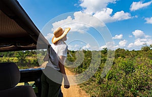 Woman enjoying view from the safari truck