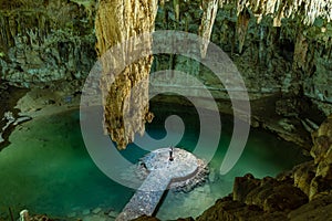 Woman enjoying the view of Suytun Cenote from the top Yucatan Mexico North America