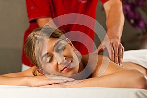 Woman enjoying wellness back massage