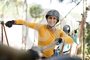 Woman enjoying zip line adventure in park