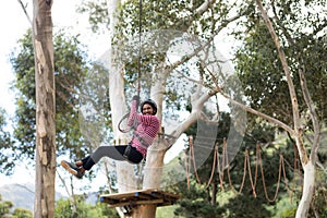 Woman enjoying zip line adventure in park