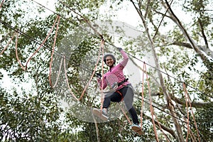 Woman enjoying zip line adventure in park