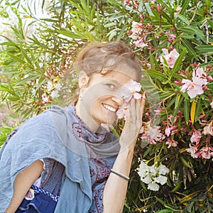 Woman enjoyng Oleander plant
