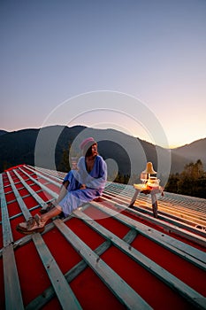 Woman enjoys beautiful sunset in the mountains
