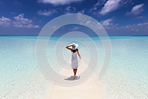 Woman enjoys her tropical vacation on a paradise beach