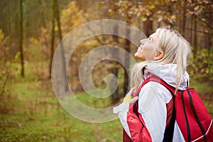 Woman enjoys hiking in wood