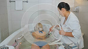 Woman enjoys the procedures of hydromassage