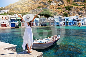 Woman enjoys the view to the village of Klima on the island of Milos, Cyclades, Greece