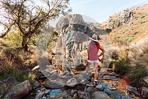 A woman enjoys views of Caves Creek Australia