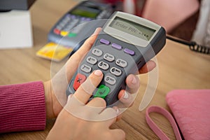Woman enters pin code payment purchase pay pass online terminal