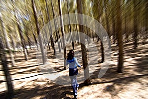 Woman escaping through the woods photo