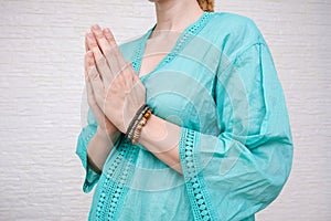 Woman ethnic clothes hold hands together is symbol prayer and gratitude, wai or namaste gesture, sign of thankfulness