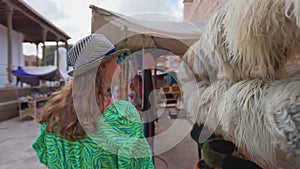 Woman in ethnic dress near Madrassah in Ichan Kala of Khiva